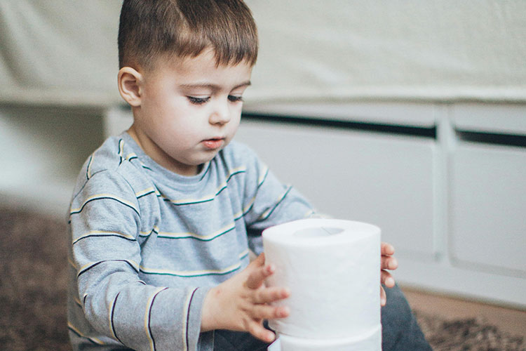 Child playing with toilet paper